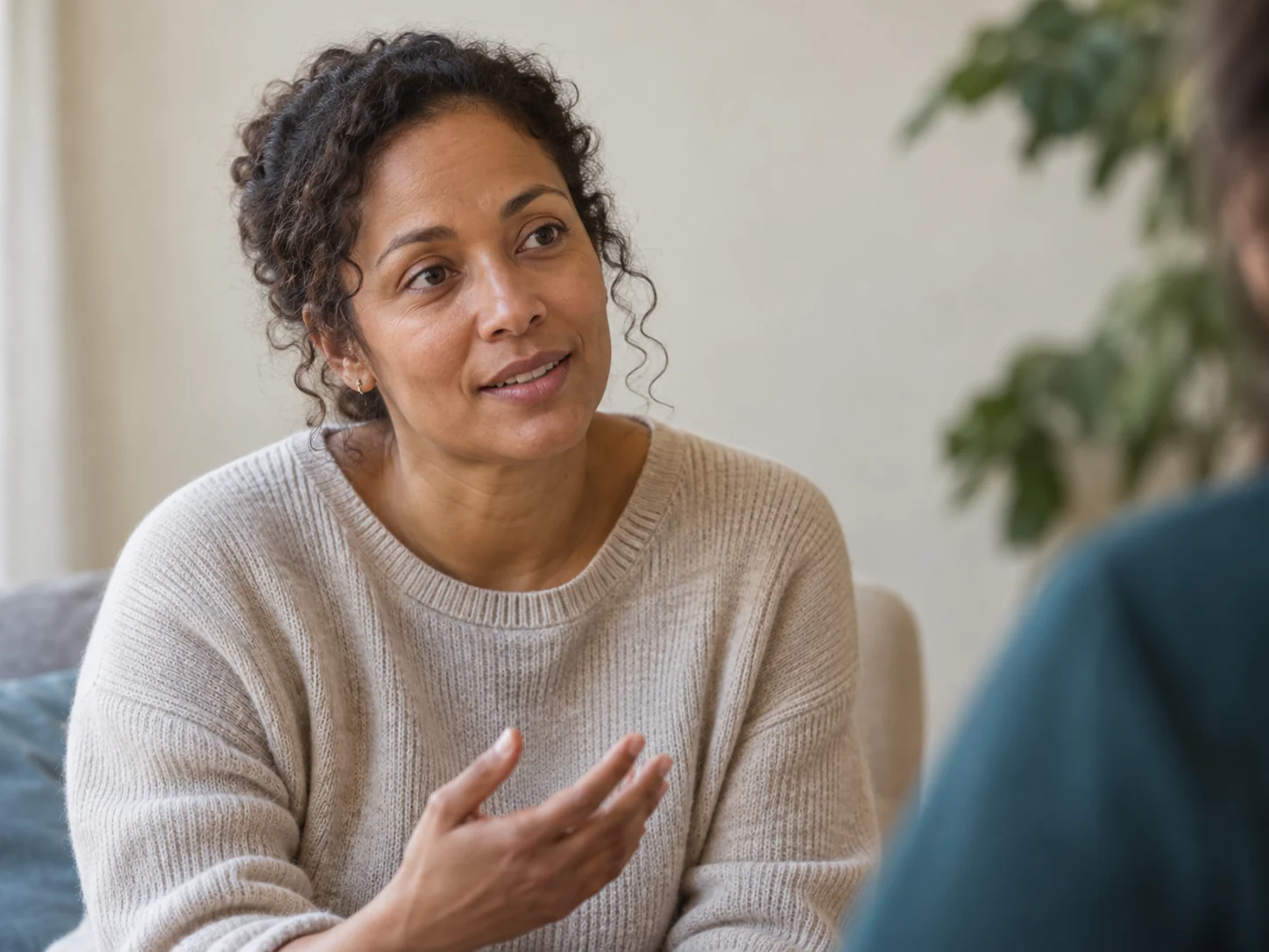 A woman sharing her thoughts with an attentive listener in soft daylight